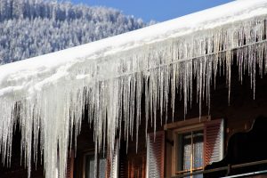 Ice dam and icicle formation on a residential roof.