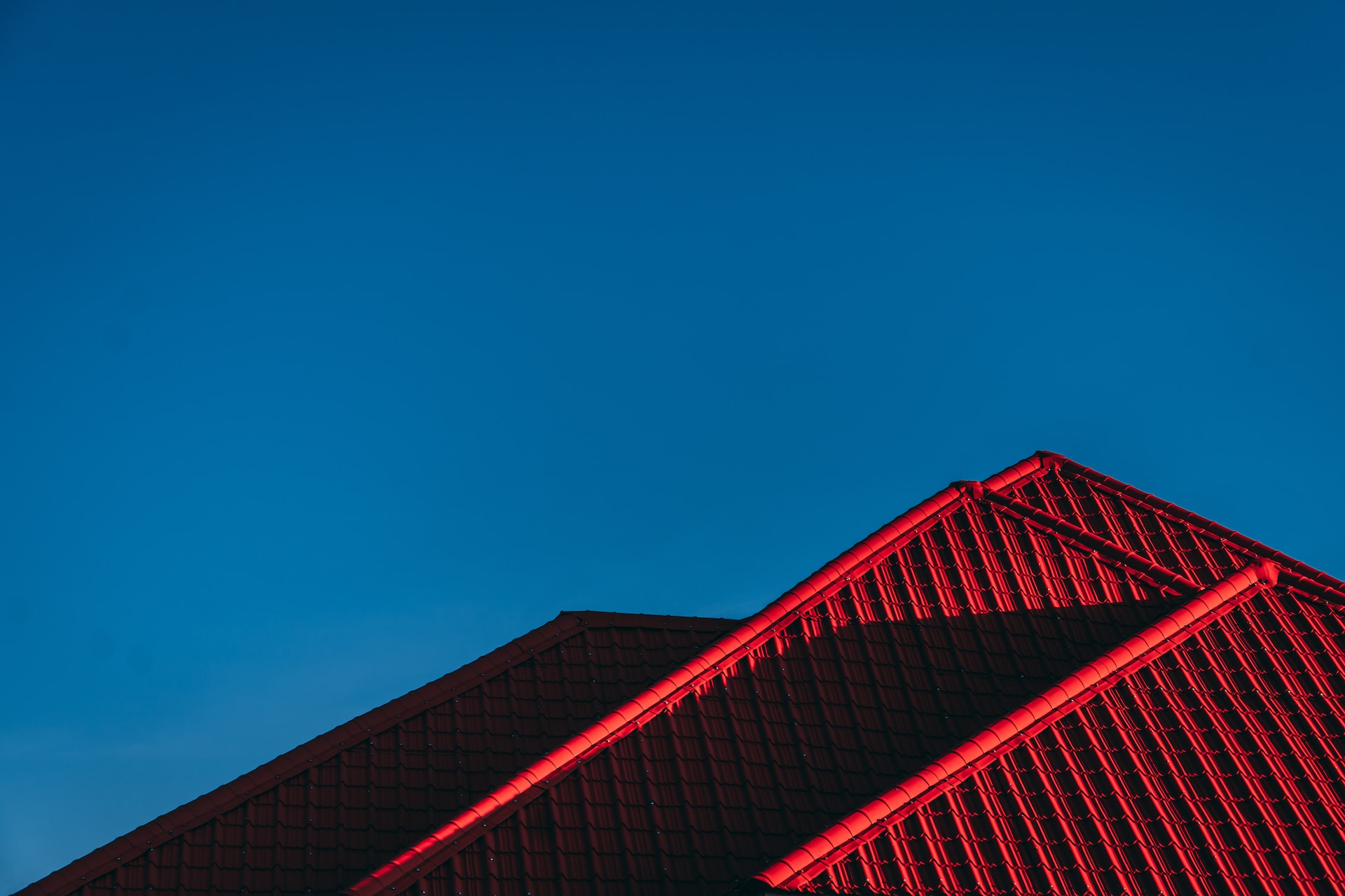 The red metal roof of a small home