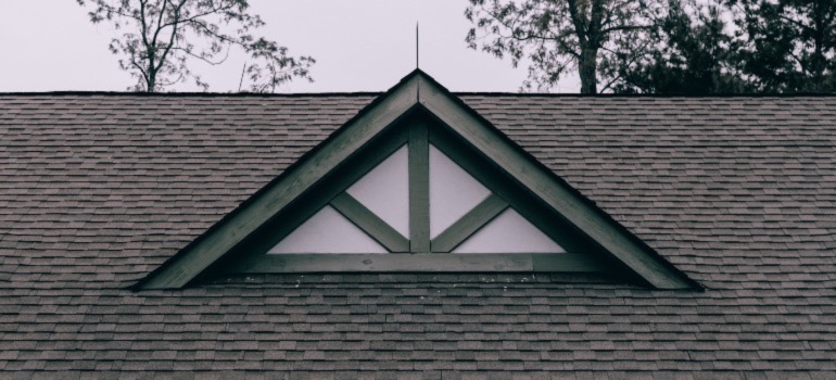 The black roof of a house.
