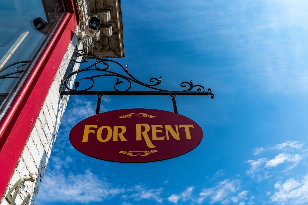 For rent sign hanging on a building.
